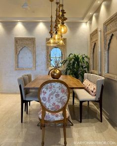 an elegant dining room with chandelier, chairs and table surrounded by potted plants