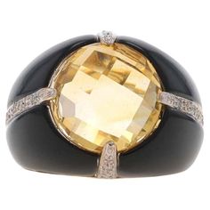 Size: 5 Metal Content: 14k Yellow Gold & 14k White Gold Stone Information Natural Citrine Treatment: Heating Carat(s): 3.45ct Cut: Double Checkerboard Round Color: Yellow Natural Onyx Color: Black Natural Diamonds Carat(s): .06ctw Cut: Single Color: G - H Clarity: SI2 - I1 Total Carats: 3.51ctw Style: Solitaire with Accents Measurements Face Height (north to south): 21/32" (16.1mm) Rise Above Finger: 3/8" (9.4mm) Weight: 6.2 Grams Stamps: 14k Condition: Pre-Owned Professionally cleaned, polished, and tested to guarantee metal content. Onyx Diamond Ring, Black Gold Ring, Onyx Colour, Citrine Ring, Natural Citrine, La Face, Gold Stone, Cocktail Rings, Citrine