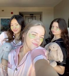 three young women taking a selfie in front of the camera with their stuffed animals