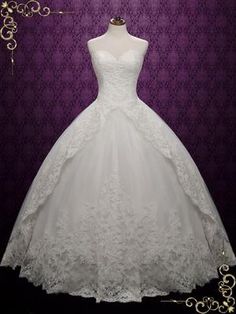 a white wedding dress is on display in front of a purple background with gold accents