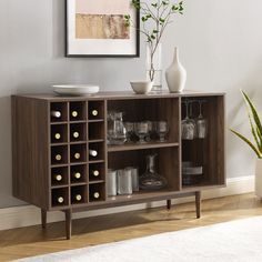 a wooden cabinet with wine bottles and glasses on it