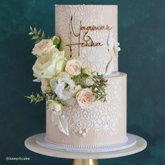 a wedding cake with flowers on top