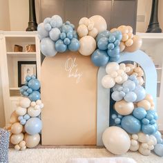 an arch made out of balloons with the word oh baby on it in white and blue