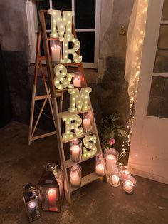 lighted letters spelling mr and mrs next to candles