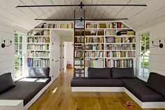 a living room filled with furniture and bookshelves