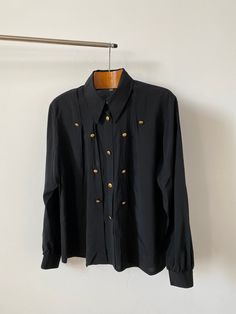 "Women blouse size M | Vintage black blouse with pleats and golden buttons.  Composition: 70% rayon, 30% polyamide Size: 38 Condition: excellent Measurements*: Armpit to armpit: 58 cm | 22.8\" Length: 66 cm | 26\" Sleeves: 62 cm | 24.4\" Shoulders: 46 cm | 18.1\" * while lying flat My shop is dedicated to vintage tops exclusively: https://www.etsy.com/shop/VintageBlouseShop?ref=seller-platform-mcnav Pay us a visit for more women black blouses!" Gold Collared Blouse For Work, Classic Gold Formal Blouse, Classic Gold Blouse For Workwear, Gold Formal Blouse With Button Closure, Gold Blouse With Button Closure For Formal Occasions, Gold Button-up Top For Work, Gold Button-up Top For Workwear, Tops With Gold Buttons For Workwear, Gold Blouse With Buttons For Work