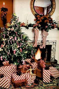 a decorated christmas tree sitting in front of a fire place with presents on the floor