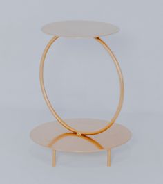 two circular tables with wooden bases on each side