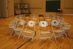 an empty gym with chairs and signs on the floor for people to sit down in