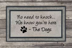 a door mat that says no need to knock we know you're here the dogs