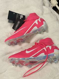 a pair of pink nike air vapor shoes on a white furnishing area with a black tag