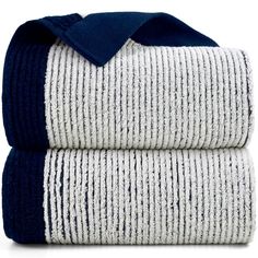 two towels folded on top of each other with blue and white trims, one is folded