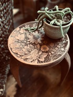 a small potted plant sitting on top of a wooden table