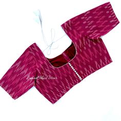 Embrace the season of festivities with this Beet Red ikkat cotton Scoop blouse. Freely mix and match with any saree, It has a contrast piping on neck and sleeves with potli buttons and a tie up. Item : Blouse Material : Handloom Ikat Cotton Size fits 38/46 ( Margins Included) Colour : Beet Root Red Sleeve length :  10.5 inches Back Neck : Scoop neck Front Neck : 6.5 inches - U Neck Padding : No Lining : Yes  Blouses are designed in-house from SumasEthnicWear  Care : Hand wash separately | line d Red Block Print Cotton Blouse Piece, Red Cotton Block Print Blouse Piece, Traditional Ikat Print Saree Blouse, Red Saree Blouse With Block Print, Fitted Ikat Print Festive Blouse, Traditional Ikat Print Festive Blouse, Fitted Ikat Print Blouse For Festivals, Festive Fitted Ikat Print Blouse, Fitted Ikat Print Blouse For Festive Occasions