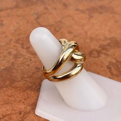 14KT yellow gold shiny, 3D, domed, weave knot, cigar band ring. Yummy and earthy chunky gold ring with open, split band. Size 6 Can be resized for an additional fee Tends to run small due to width Width: 14mm at widest point Back slightly tapers Stamped 14K Weight: 6.50 grams Modern Gold Dome Ring With Open Design, Twisted Gold Ring For Gift, Gold Wide Band Ring With Modern Twist, Gold Rings With Modern Twist And Wide Band, Twisted Gold Anniversary Rings, Cigars, Band Ring, Gold Ring, Band Rings