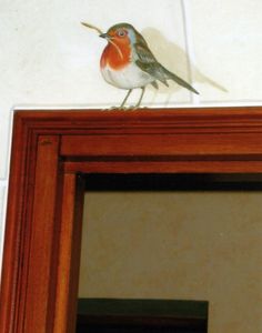 a small bird perched on top of a mirror