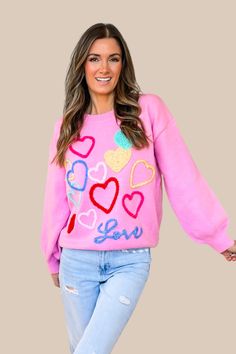 Restocked! The cutest sweater for Valentine's Day or year round! Our Love Tinsel Sweater in Pink is a soft knit sweater featuring a crew ribbed neckline, long sleeves, ribbed cuffs and hemline, tinsel heart details in blue, pink, red, yellow, green and white, and love wording in blue script. Fit: True to size. 39% Acrylic, 31% Polyester, 30% Nylon. Hand wash cold, line dry. Model Measurements: Height 5'5", Bust 33", Waist 25", Hips 33" wearing a size Small. Tinsel Sweater, Cute Long Sleeve Valentine's Day Sweater, Pink Heart Print Sweater For Valentine's Day, Valentine's Day Long Sleeve Sweater With Heart Graphic, Pink Heart-shaped Valentine's Day Sweater, Red Heart-shaped Valentine's Day Sweater, Ribbed Neckline, Cute Sweaters, Pink Sweater