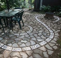 a table and chairs sitting on top of a stone patio