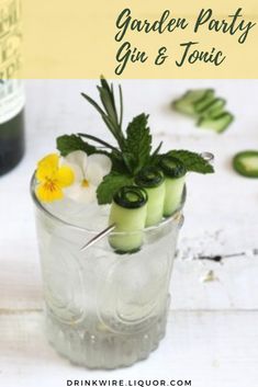 a glass filled with cucumber and mint garnish