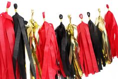 red, black and gold tassels hanging from hooks