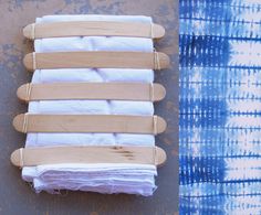 four pieces of wood sit next to each other on a blue and white tie - dyed background