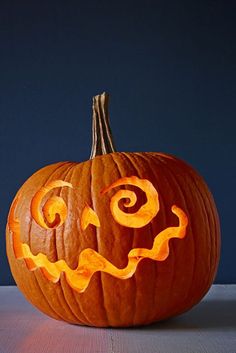 a carved pumpkin with an evil face on it