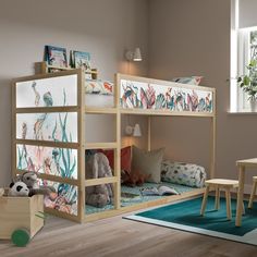 a child's bedroom with a bunk bed and toys on the floor in front of it