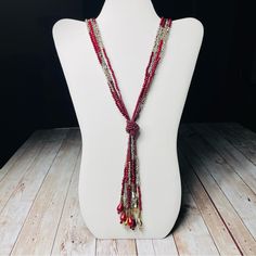 Multi Stands Of Dark Red Bead’s Knotted Together Into A Tassel Of Beads And Crystals. It Is A 16 In Drop To The Tassel And The Tassel Extends Approximately 5 More Inches. Elegant Red Beaded Necklace With Colorful Beads, Elegant Red Beaded Necklace, Red Beaded Lariat Jewelry, Red Long Beaded Necklaces For Party, Long Red Beaded Necklaces For Parties, Red Long Beaded Necklace For Party, Party Red Beaded Necklaces, Elegant Red Long Beaded Necklace, Elegant Long Red Beaded Necklace