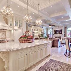 a large kitchen filled with lots of counter top space next to a dining room table