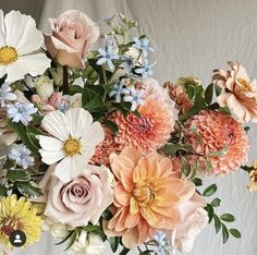 a vase filled with lots of different colored flowers