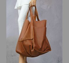 "Oversized carryall handbag, Leather tote bag with pocket, Giant oversize tote bags, Carryall shopper bag soft leather, Camel brown tote This oversized bag has been carefully designed to be the perfect everyday bag. The size makes it practical for carrying everyday essentials. Made from 100 percent Italian leather. This bag is available in different colors, check in my store.   * Includes two large internal pockets for mobile phone and other small items. * Top closure magnet for security. Height: 39 cm / 15.3\" Height from top of handle to base: 68 cm / 26.8\" Handle drop: 26 cm / 10.2\" Width: 34 - 74 cm / 13.4\" - 29.1\" Depth: 28 cm / 11\" The leather of this product has been produced in an audited and certified tannery in Italy.    To return to my shop, simply click here: https://www.e Everyday Hobo Tote Bag With Pockets, Large Brown Rectangular Satchel, Large Rectangular Brown Satchel, Large Brown Satchel For Daily Use, Light Brown Hobo Tote Bag For Shopping, Light Brown Tote Hobo Bag For Shopping, Large Capacity Light Brown Hobo Bag With Double Handles, Large Brown Chic Satchel, Chic Large Brown Bag