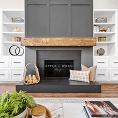 a living room with a fireplace and bookshelves in the back ground, surrounded by white bookcases