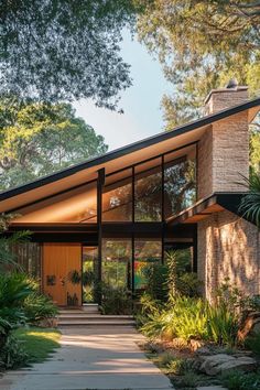 a modern house in the middle of trees and plants