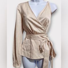 This Bcbgmaxazria Wrap Top Features A Single Long Sleeve, An Adjustable Shoulder Strap And A Tie Closure At The Waist. Style V-Neck; Tie Closure At The Waist Brand: Bcbgmaxazria Size: Xxs Condition: New With Tags. Color: Beige Pattern: Solid Material: 60% Viscose, 40% Polyester Care: Hand Wash Approx. Measurements (Flat): Bust: 17" Sleeve: 25" Length: 25" Across The Bottom: 21" Fitted Long Sleeve Faux Wrap Top, Chic Long Sleeve Faux Wrap Top, Chic Long Sleeve Wrap Top For Party, Chic Beige Wrap Top, Spring Formal Wrap Top, Formal Wrap Top For Fall, Formal Fall Wrap Top, Chic Fitted Wrap Top For Evening, Chic Wrap Blouse For Party