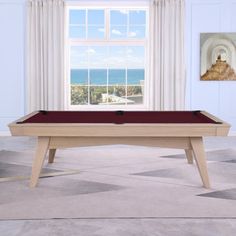 a pool table in front of a window