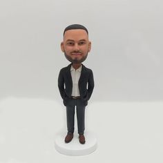 a man in a suit and tie bobble head