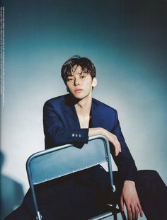 a man sitting on top of a metal chair