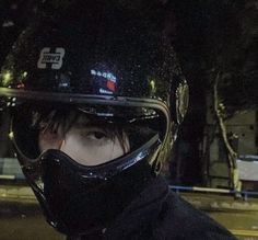 a man wearing a motorcycle helmet and goggles