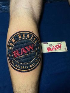 a man's arm with a tattoo on it that reads raw, and the word raw written in red