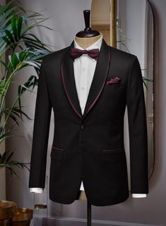 Formal elegance doesn't come more sartorially refined than in the Italian Style Black Wool Tuxedo Suit. Own a great quality Tuxedo all custom hand made just for you. Sometimes the best formal attire is all about going back to the basics and doing them well.   Tuxedos are great way to standout from the crowd, while maintaining a timeless and elegant look.     Featuring wine satin lapel, matching satin covered buttons and gentle texture at its surface, our tuxedo is a subtle fashion-forward take on a traditional tailoring.   Look Includes   Black Merino Wool    Two Button Tuxedo Jacket Style   Shawl Lapel   Wine Tuxedo Buttons  Single Vent  Three Cuff Buttons  Two Welted Back Pockets on Trousers   You can change the look by changing the options listed.  Lining: Viscose; Dry Clean. Tuxedo Suit, Tuxedo Jacket, Formal Attire, Black Wool, Italian Style, Jacket Style, Fashion Forward, Satin, Trousers