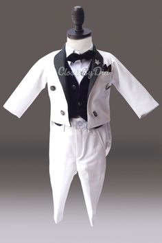 Classy and handsome tailcoat for boy in white and black is an ideal pick to grace weddings, first birthdays and christening ceremonies. Milk/ black color suit which is a 5 piece suit with pants, tailcoat, black waistcoat, shirt and bowtie. It is a timeless boy wedding outfit to dress like a royal British Prince. This wedding costume for boys is a fine work of designing. newest collection of Trendy tailcoat suits and costumes for toddler boy. Enjoy worldwide shipping with this dress tailcoat for White Long Sleeve Tuxedo For Party, White Tuxedo Set For Party, White Tuxedo Party Set, White Tuxedo Style Party Set, Elegant White Suits For Baptism, Classic White Party Sets, First Birthday Outfit Boy, Toddler Boy Costumes, British Prince