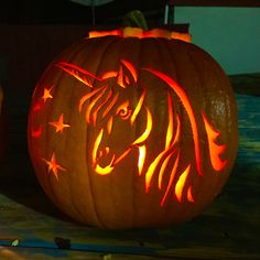 a carved pumpkin with an image of a unicorn on it