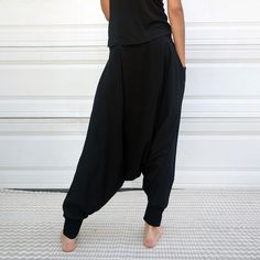 "Black Samurai Style Ninja Pants for Women and Men. This Stretch Cotton Harem Pants Fit Plus Size. -Unisex -Stretch -Flowing relaxed fit -Inner drawstring to secure the waist -2 side pockets Great for Yoga, Dance, Exercises, Meditations, Yoga Practice and beyond... Materials: black color cotton blend (90% cotton 10% lycra). Fabric for this pair were bought in Fashion District, LA and the pant was made in one of the studios in Los Angeles, CA. Measurements: Fits: S, M, M/L -Length: 41\" (~102 cm) Baggy Full-length Harem Pants For Loungewear, Harem Pants With Pockets For Loungewear, Harem Loungewear Bottoms With Pockets, Casual Harem Bottoms With Side Pockets, Full-length Harem Pants With Side Pockets, Solid Color Full-length Harem Pants With Side Pockets, Black Tapered Leg Loungewear Bottoms, Baggy Tapered Leg Loungewear Pants, Black Parachute Pants With Pockets For Loungewear