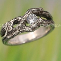 a silver ring with a diamond in it