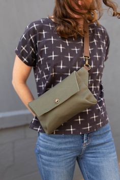 a woman holding a green purse in her hands