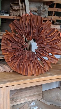 a wooden table topped with a large metal object