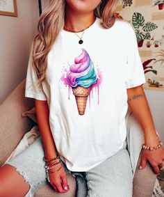 Introducing our Watercolor Ice Cream Shirt 🍦!  Embrace your sweet tooth with this vibrant and delicious design. 🍨 ✨ Made with soft, high-quality fabric, this shirt is as comfortable as it is eye-catching. 👕👌 Perfect for summer days, ice cream lovers, and anyone who wants to add a touch of sweetness to their wardrobe! 🌞🍦 Indulge in the utmost comfort and style with our BlendedApprl Unisex T-shirts. Crafted with premium quality, these tees are incredibly soft and cozy to wear. They are made from a blend of 100% cotton for solid colors and a soft cotton-polyester mix for heather colors. Rest assured, we trust BELLA+CANVAS for delivering top-notch T-shirts! FABRICATION * Direct to Garment printing methods * Solid Colors: 100% Ringspun Cotton * Heather Colors: 52% cotton, 48% polyester * White Cotton Cartoon Print Sublimation Design, White Cotton T-shirt With Cartoon Sublimation Design, Sweet White T-shirt With Graphic Print, Sweet White Tops With Cartoon Print, Cute Colorful Short Sleeve T-shirt, Casual Cotton Sublimation T-shirt With Cartoon Print, Cute Tie Dye Graphic Print T-shirt, Cute Tie Dye Graphic T-shirt, Cute Tie-dye Graphic Print T-shirt