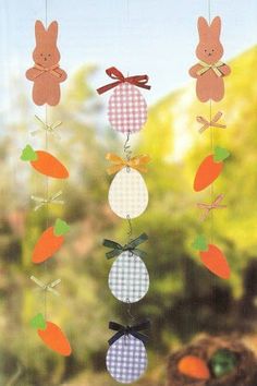 an image of a baby mobile with carrots and bunnies hanging from it