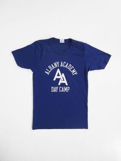 "Vintage Albany Academy T-shirt Blue Champion Tee - Youth Large Excellent condition, American made by Champion. Label size Youth Large but please compare the measurements below to your favorite t-shirt, laid flat, to ensure a proper fit. Shoulder: 13\" Chest: 14 3/4\" Length: 22 3/4\" Sleeve: 7 1/4\" See more vintage items: www.etsy.com/shop/memoryvintage Policies & measurement guide: www.etsy.com/shop/memoryvintage/policy Instagram @memoryvintage" Basic Blue Pre-shrunk T-shirt, Blue Cotton T-shirt With Text Print, Blue Graphic Tee With Letter Print, Basic Blue T-shirt With Screen Print, Basic Blue Tops With Text Print, Pre-shrunk Blue Crew Neck T-shirt, Blue Crew Neck T-shirt With Screen Print, Blue Crew Neck T-shirt With Letter Print, Blue Letter Print Basic Shirt