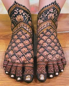 the feet are decorated with intricate designs